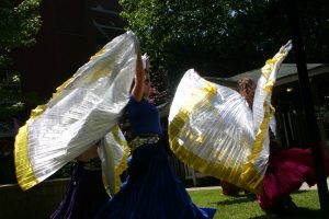 Dancers with colourful skirts and golden wings