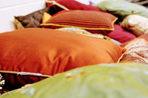 Colourful cushions spread over the ground